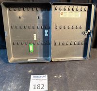 Cabinet open showing 50 hooks and interior tag