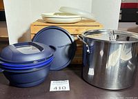 All items overview: blue Tupperware steamer disassembled, off-white tray, stainless steel pot