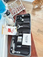 All items grouped: garnishing set open, chopper, shaker, cookbook stand