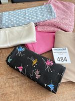 Overview of six assorted fabric remnants on table