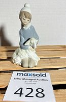 Front view of Lladro figurine showing girl holding lamb