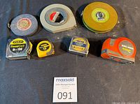 Group shot of all seven measuring tapes – three open-reel and four pocket tapes