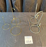 All five metal display stands grouped on table