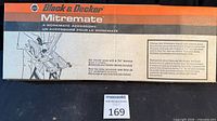 Front of boxed Black & Decker Mitremate accessory showing brand and Workmate compatibility
