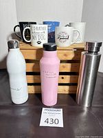 Front view showing all mugs and bottles