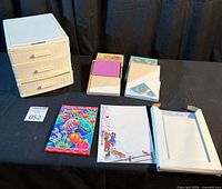 overview of storage organizer and multiple boxed greeting card sets on table