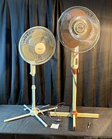 Both pedestal fans front view