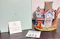 Tealight house beside PartyLite box and product card