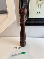 Front view of entire pepper mill next to marker for scale