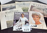 Group shot showing four newspapers and two Maclean’s magazines