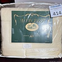 Front view of packaged king size pure virgin wool sheets showing Aircrest insert and cream colour