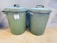Both Rubbermaid garbage cans with lids on