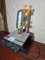 Front angled view of Ryobi BS903 band saw showing table, blade, and power cord