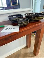 All four matching brown ceramic bowls displayed on table