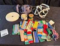 Overall lot showing bias tape packages, rolls of tape, ribbon coils, Velcro and elastic