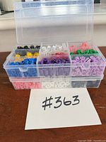 Both clear plastic boxes closed and stacked showing various coloured size beads