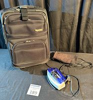 Suitcase front view and travel iron