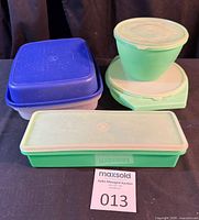 Overall lot showing four Tupperware containers with lids