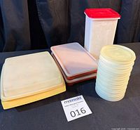 Group shot of all pieces: cracker keeper, deviled egg platter, wiener keeper, stack of patty discs