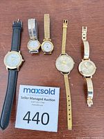 Five watches laid out showing overall styles and materials