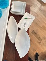 All six white porcelain serveware pieces grouped