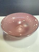 Oblique view of pink speckled glass bowl