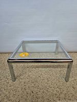 Top angled view of chrome frame and glass top table