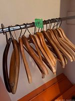 group of wooden hangers on closet rod