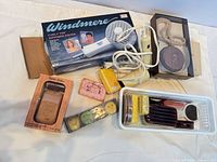 Group shot of all items including boxed Windmere dryer, soaps, grooming tools