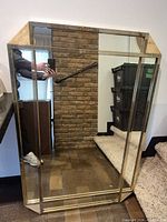 Front view of mirror showing metal frame, travertine corners and overall size