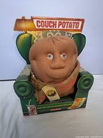 Front view of Couch Potato plush in original display box