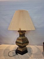 Full view of brass table lamp with shade