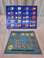 Both display boards open: world coin/flag album and Prime Ministers medallion board
