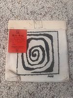 Front of swatch book showing SaMo header, red tag, and black-and-white spiral 'Joker' sample