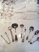 overview of all eight sterling utensils laid out