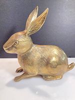 Left side view of brass rabbit figurine