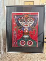 Full view of framed artwork standing on carpet