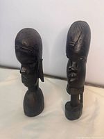 Front view of both ebony bust sculptures