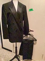 Full view of jacket on mannequin with pants on hanger
