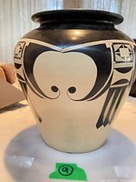 Front view of black and cream Southwest style ceramic vase