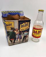 Bottle next to carrier showing labels and graphics