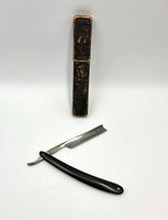 Straight razor opened with case in background