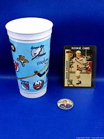 Group shot of cup, Messier card in case, and Bill Gadsby coin