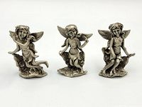 Front view of three pewter fairy figurines