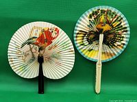 Both paper hand fans displayed open