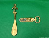 Shoe horn and bottle opener side by side