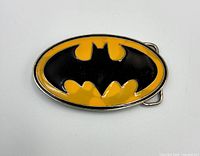 Front view of oval Batman logo belt buckle