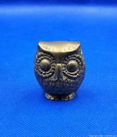 Front view of solid brass owl figure