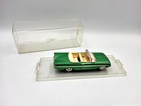 Diecast car on base with display lid beside it