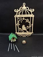 All three items: birdcage cut-out, birdhouse chime, trinket box